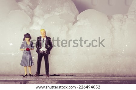 Miniature businessman family work with  stone ice concept winter day with retro filter