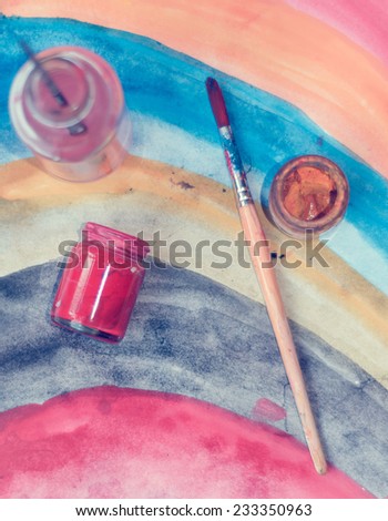 paintbrushes and color bottle for painting with retro filter