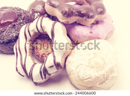 lot of tasty donuts food pattern on white with retro filter