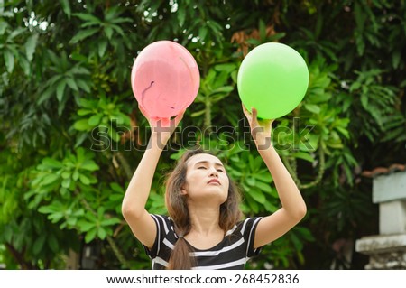 asia girl play color balloon at nature outdoor