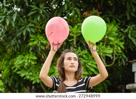 asia girl play color balloon at outdoor background