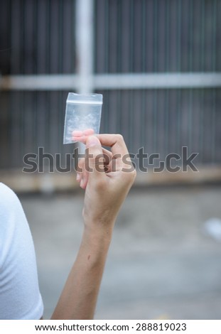 hand hold medicine in plastic package on outdoor