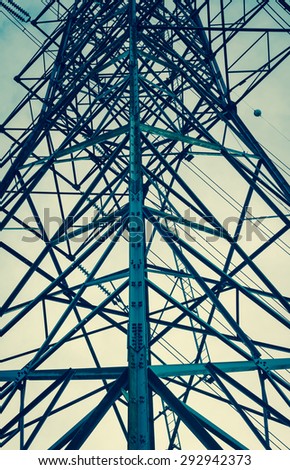 high voltage tower with retro filter on sky background