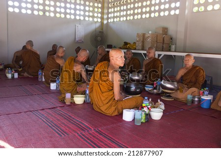 CHIANGMAI, THAILAND - AUGUST 11: buddhist monk is waiting for breakfast given by people who want to make great merit on August 11, 2014, in Suantummarot temple, Doilor district of Chiangmai, Thailand.