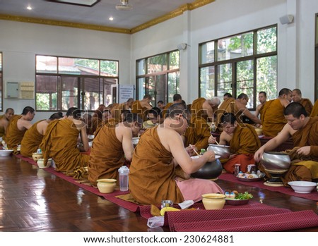 CHIANGMAI, THAILAND - SEPTEMBER 29: buddhist monk have breakfast given by people who want to make great merit on September 29, 2014, in Arunyavivek temple, Maetang district of Chiangmai, Thailand.