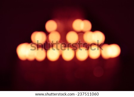 the blurry defocused image of yellow lighting from chandelier with yellow highlight and red shadow