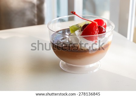 chocolate pudding mousse with mix fruit and cream on top
