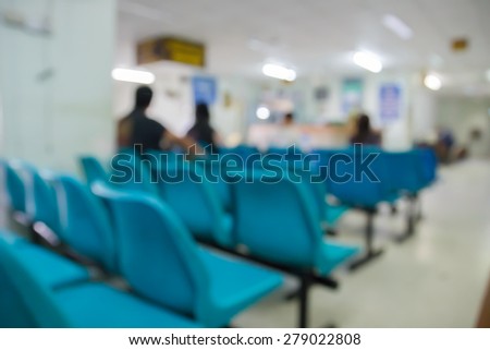 blurry defocused image of patient sitting on chair waiting for doctor in public hospital for background