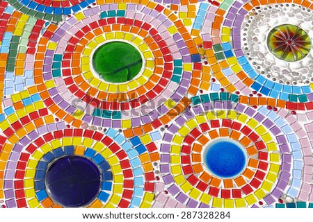 the art design of the colorful broken tile and thailand traditional bowl decorating on temple wall for abstract background