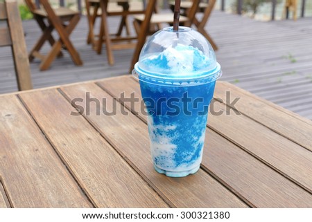 cup of blue lemon smoothie on wooden table