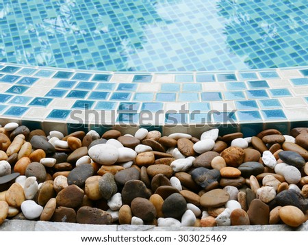 small stone decorating on the edge of the swimming pool