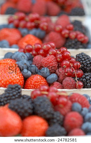 Hawker\'s stand with different berries. Shallow depth of field.