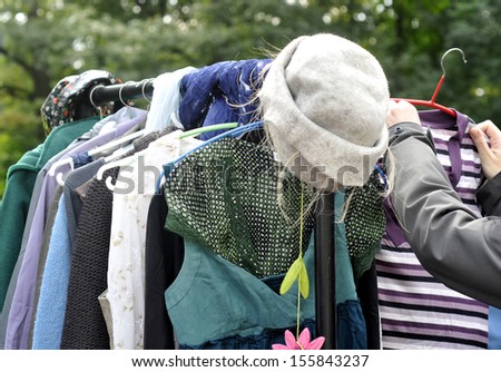 clothes on a rack in a flea market