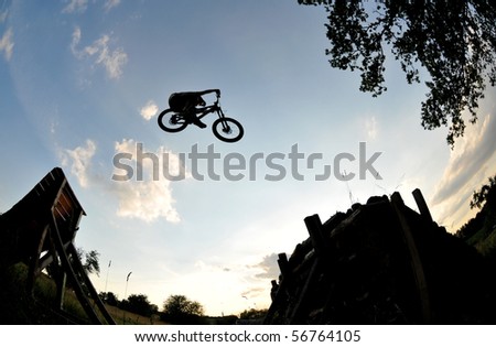 Silhouette of a man doing a mountain bike jump