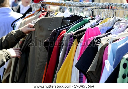clothes on a rack in a flea market
