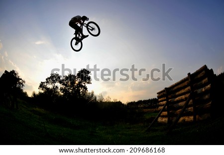 silhouette of a man on a mountain bike