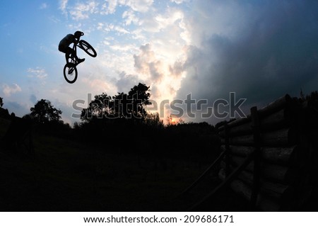 silhouette of a man on a mountain bike