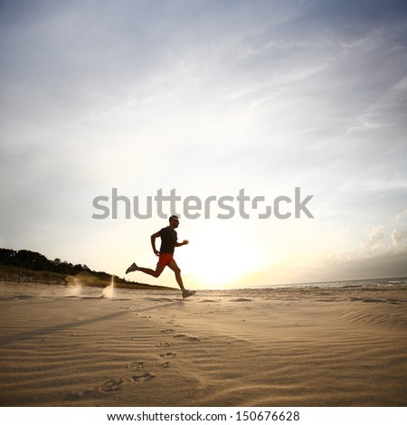 Man Running On Beach At Sunset