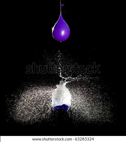 Balloon with water bursting punctured by arrow.High speed photography.