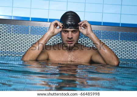 Artistic portrait of swimmer resting on swimming pool