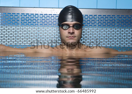 Artistic portrait of athlete swimmer in water