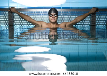 Artistic portrait of swimmer resting on swimming pool