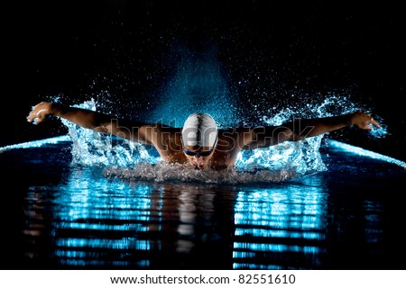 Taking breath swimming butterfly isolated black background