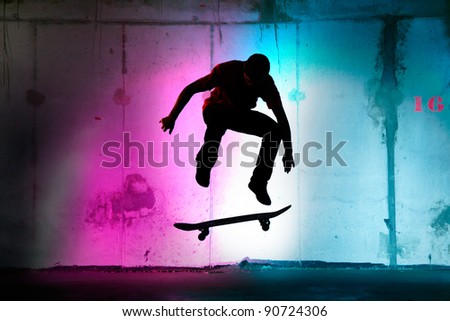 teenager jumping, skateboarding at night black silhouette