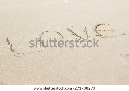 word love written in sand background