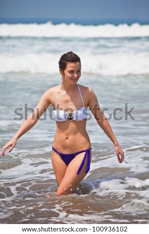 Summer holiday on exotic islands. The girl bathes at the ocean