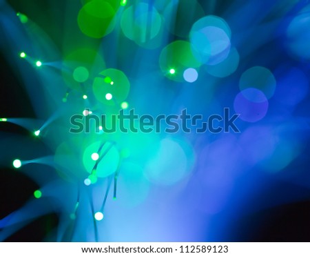abstract background of dark blue and green optical fiber spot lights