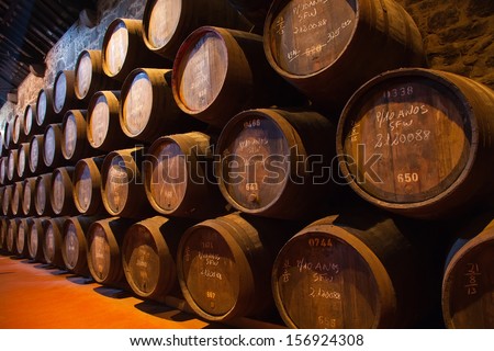 Wooden Barrels Hold Port Fortified Wine To Mature In Wine Cellars , Portugal
