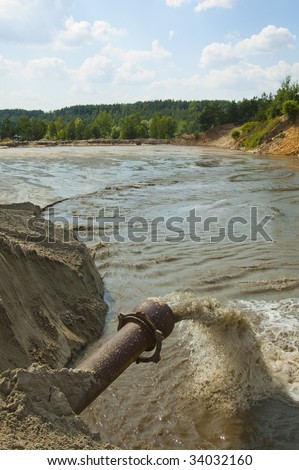 Dirty water flows from a pipe. Toxic production wastes
