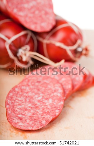 long loaf of smoked sausage lies on chopping board