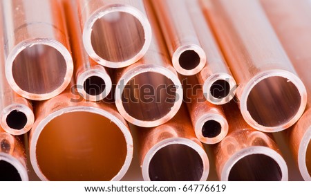 Set of copper pipes of different diameter lying in one heap