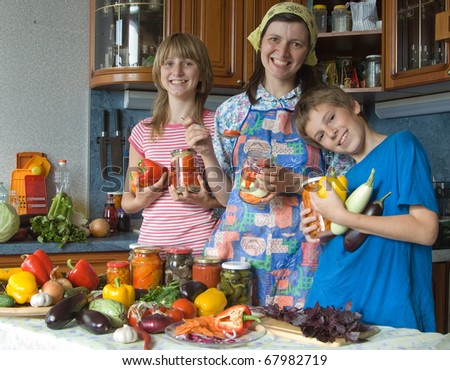 The happy housewife. Amicable family on kitchen. House conservation of vegetables.