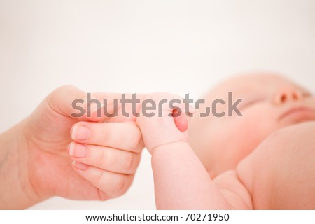 The small child is held by the hand the parent. Care and support.