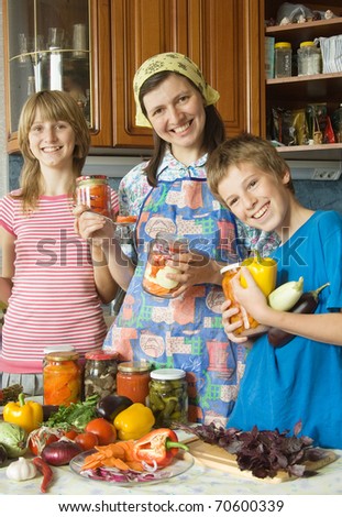 The happy housewife. Amicable family on kitchen. House conservation of vegetables.