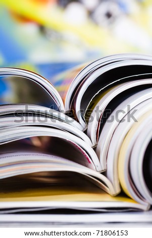 Closeup background of a pile of old magazines with bending pages
