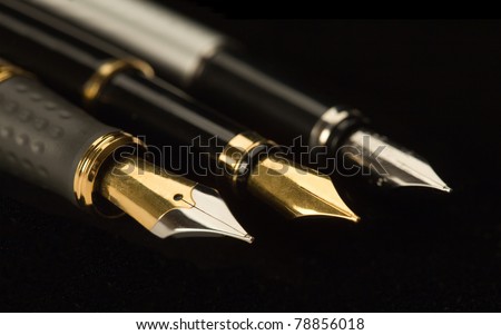 Three stylish ink pens for the letter. Isolated on a black background