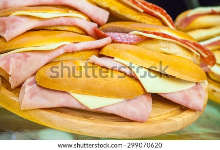 Cheese and ham sandwiches on a show-window of shop
