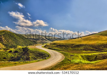 Cycling mountain road. Misty mountain road in high mountains.. Cloudy sky with mountain road