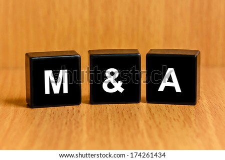 M&A or Merger and Acquisition text on black block