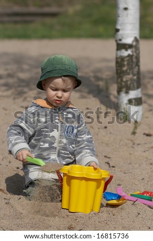 Boy plays in sand