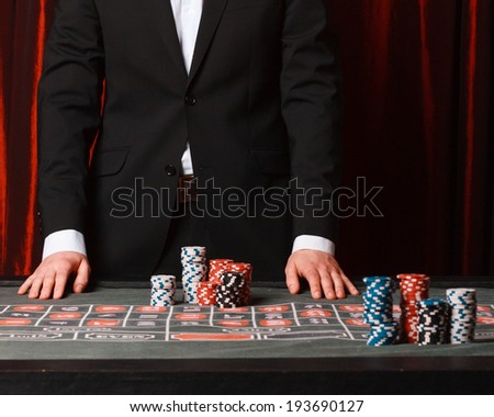 Man placing a bet at the casino., studio shot