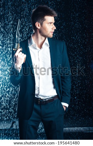 shot of quiet businessman with gun