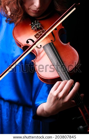 Music portrait of young woman.  Violin play. Close up face beautiful model.