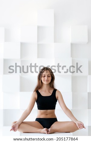 Beautiful woman doing yoga in studio. studio shot