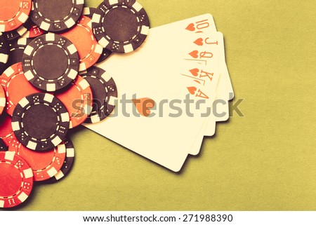 Poker cloth, a deck of cards, poker hand and chips. Background.