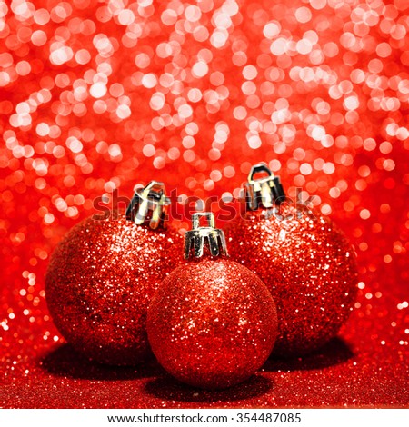Beautiful red christmas balls on abstract glitter background close-up
